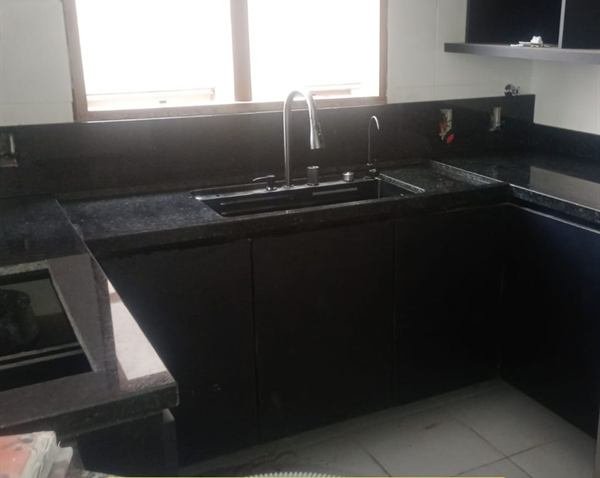 Cozinha em U com bancada em pedra escura